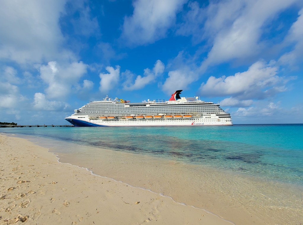 Carnival Magic docked at a Caribbean cruise port.